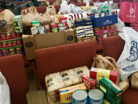 Nonperishable goods for the food drive slowly pile up in the chapel.