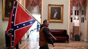 Man carries the Confederate flag through the halls of Congress
Photo Credit: Saul Loeb