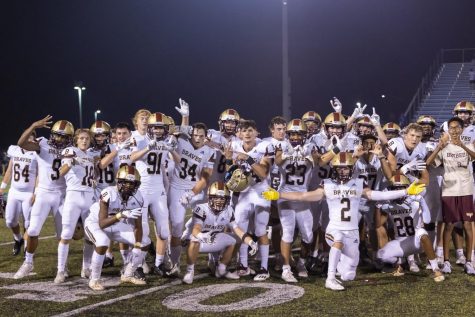 The Brebeuf varsity football team celebrates its victory Friday over Bishop Chatard.
