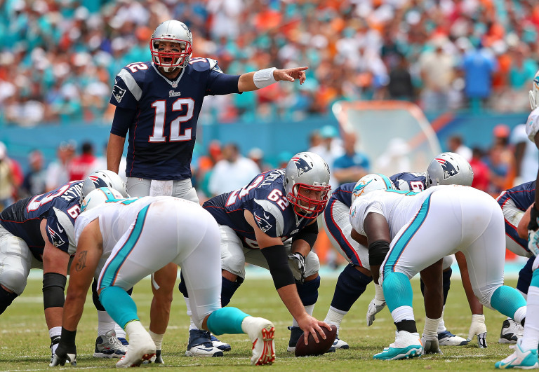 MIAMI GARDENS, FL - SEPTEMBER 07:  Tom Brady #12 of the New England Patriots calls a play during a game against the Miami Dolphins at Sun Life Stadium on September 7, 2014 in Miami Gardens, Florida.  (Photo by Mike Ehrmann/Getty Images)