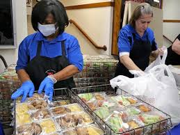 People helping to package food during the Coronavirus crisis as school food services are disrupted.
Photo Credit: JSOnline