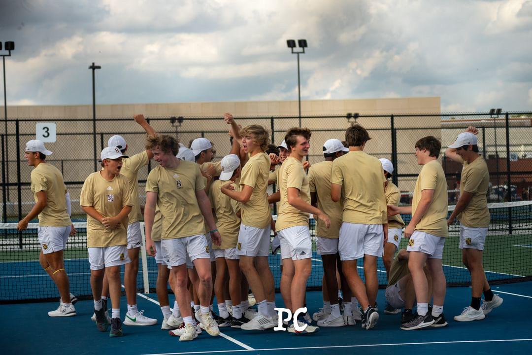 Boy's Tennis Team celebrates after a win versus North Central High School. 