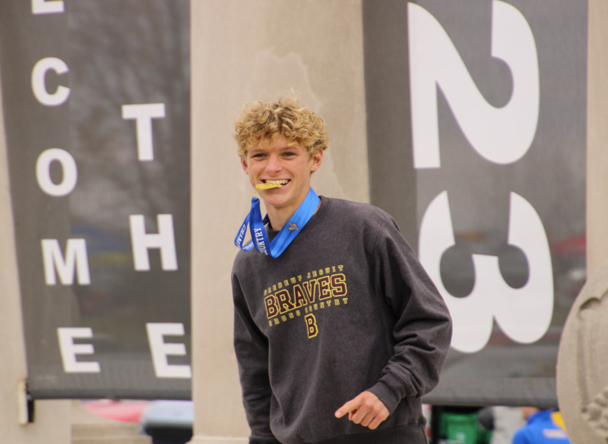 Cameron Todd '24 recieves his medal after placing first at state.