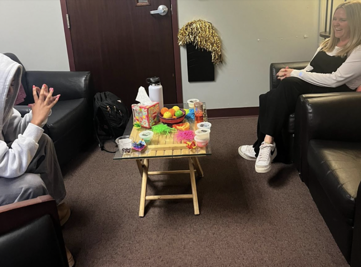 Mrs. Pollak talking to a student in her office 