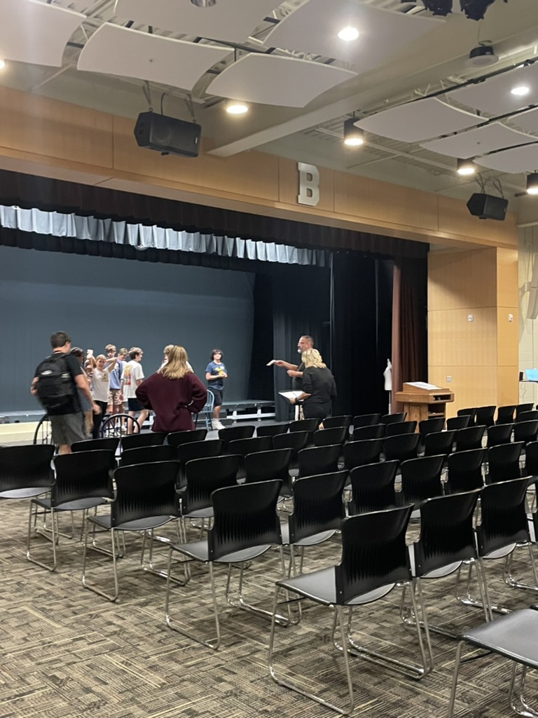 The cast of the play holds an after school practice in the auditorium.