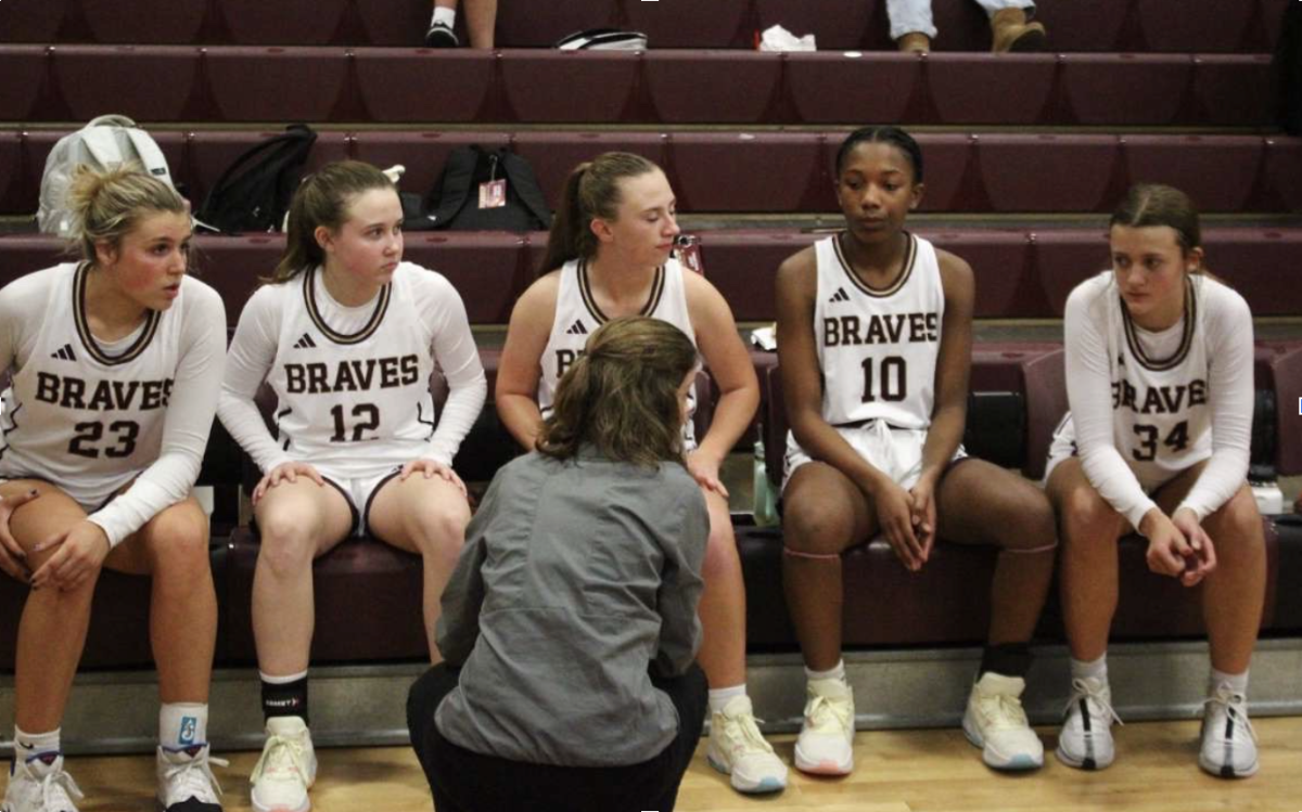 Brebeuf team in a huddle mid-game, discussing strategies on how to win.